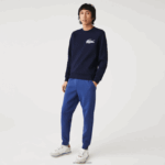 Lacoste מכנסי אימונית של אימונית בגזרת כותנה מחוסמת בגזרה דקיקה DZ4D0D1140 כחול chine hjd גברים