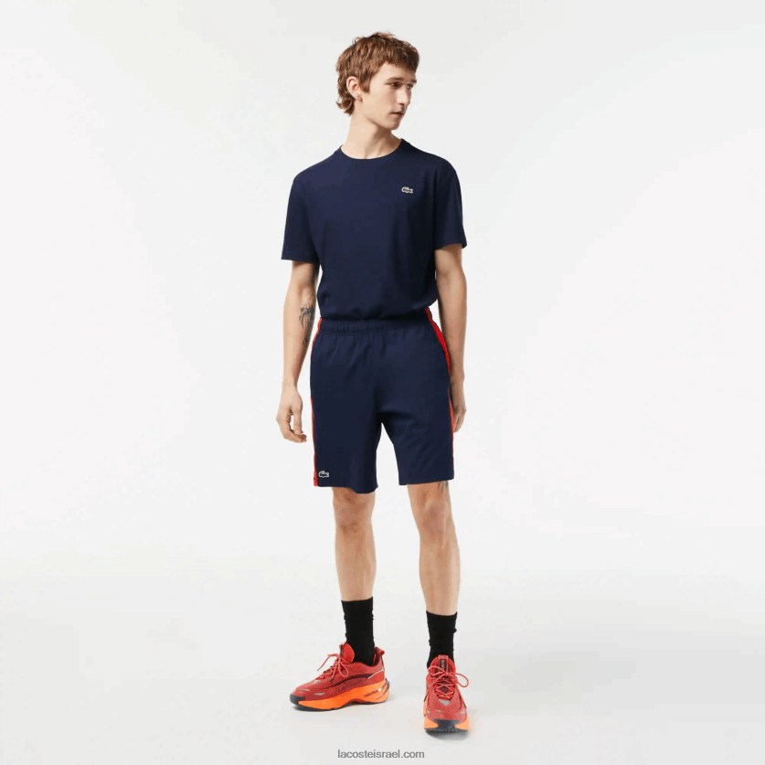 lacoste_d79ed79bd7a0d7a1d799_d798d7a0d799d7a1_d7a7d7a6d7a8d799d79d_d79ed7a4d795d79cd799d790d7a1d798d7a8_d79ed79ed795d797d796.png Lacoste מכנסי טניס קצרים מפוליאסטר ממוחזר DZ4D0D426 כחול כהה אדום כתום xii גברים - Image 1